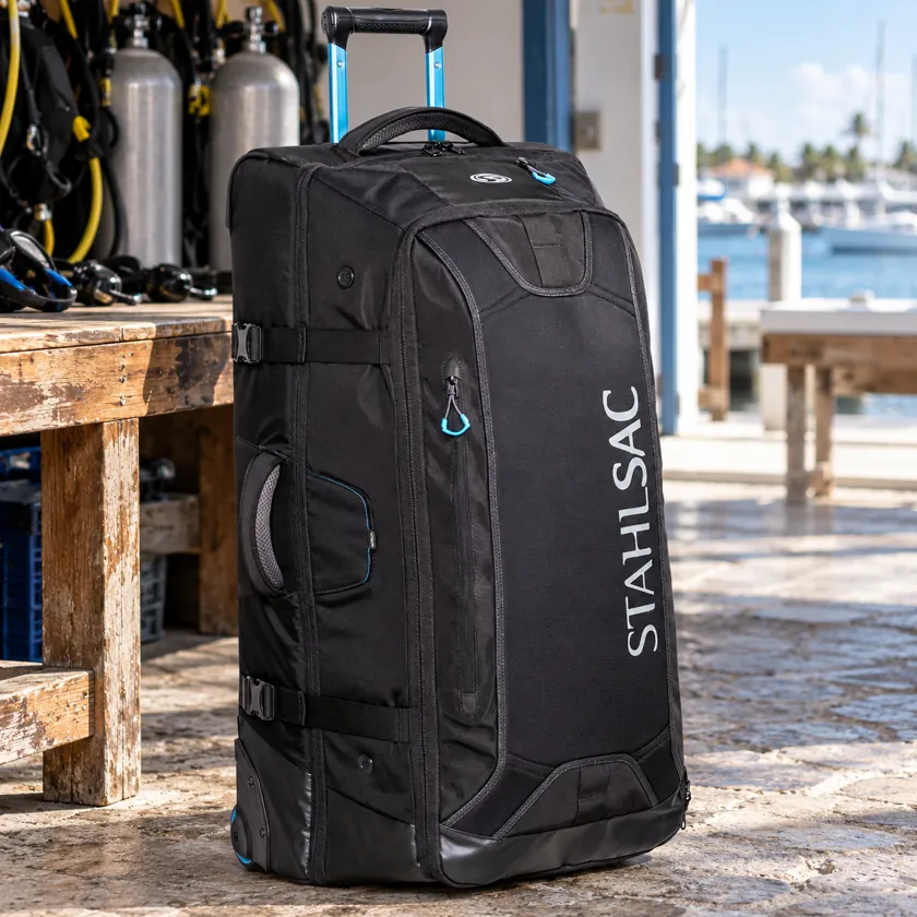 Generated product image of Stahlsac 34 Inch Steel Wheeled Bag resting in a dive-center packing area